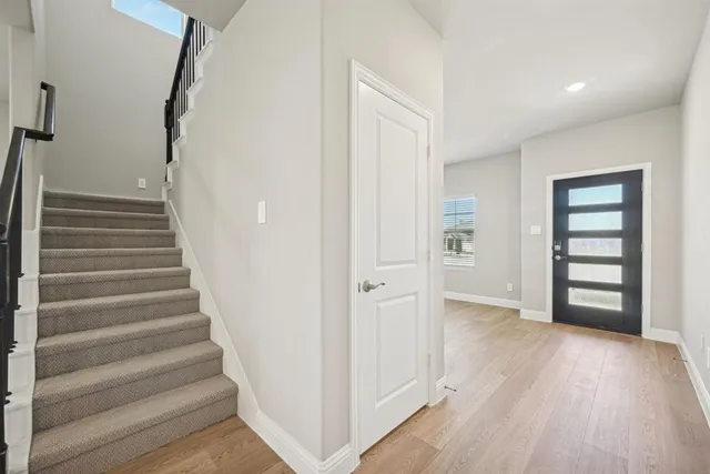 a view of an entryway with wooden floor
