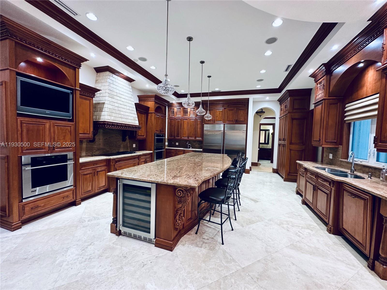6180 Southwest 132nd Street Pinecrest, FL 33156 - Photo 17 of 75 a kitchen with stainless steel appliances kitchen island granite countertop a stove a sink and a refrigerator