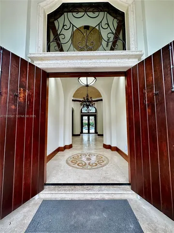 an empty room with a fireplace and windows