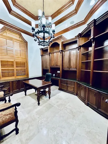 a view of a livingroom with furniture staircase and a chandelier