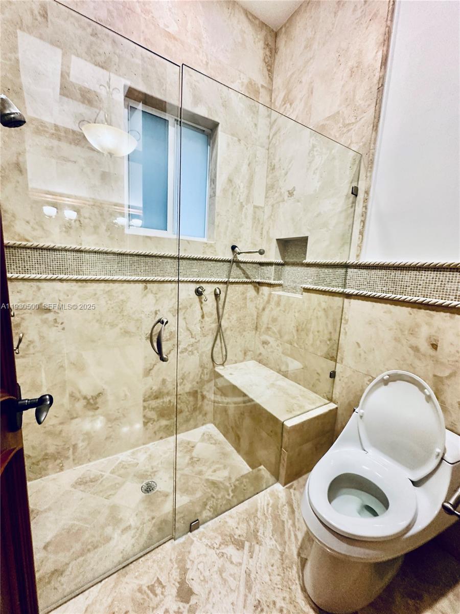 6180 Southwest 132nd Street Pinecrest, FL 33156 - Photo 36 of 75 a bathroom with a sink a toilet and a mirror