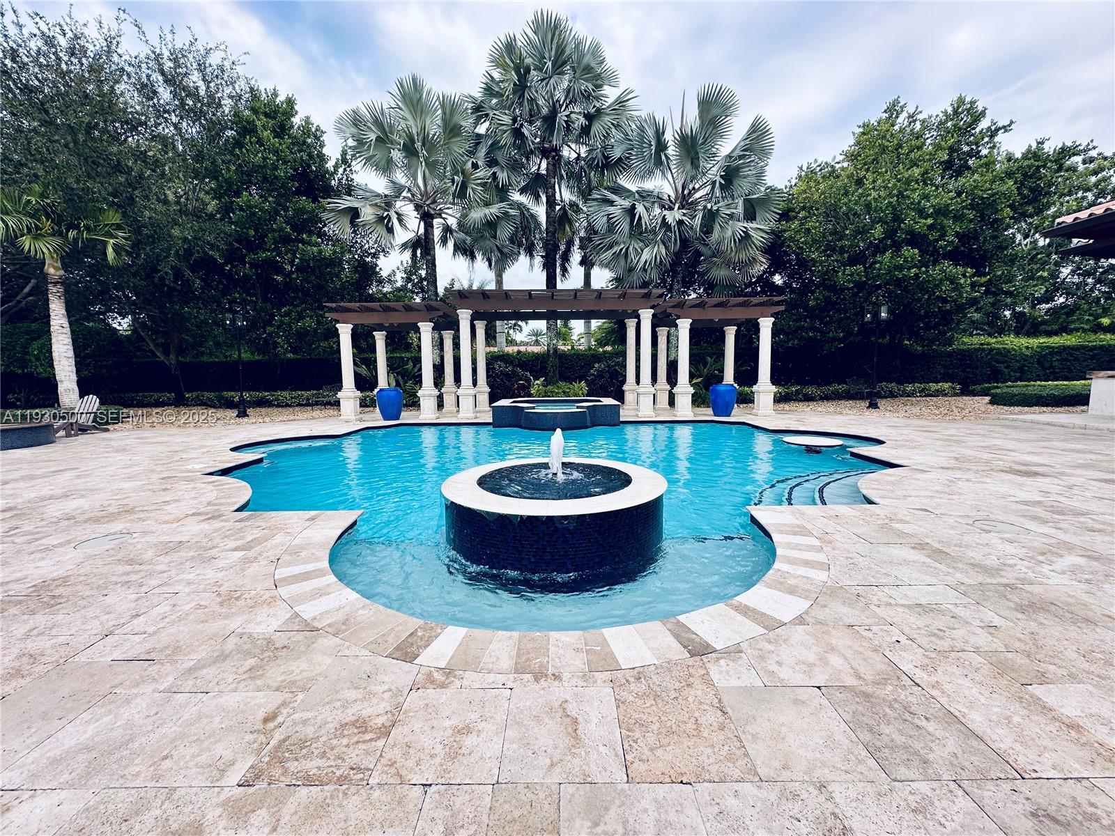 6180 Southwest 132nd Street Pinecrest, FL 33156 - Photo 52 of 75 a view of a house with swimming pool and sitting area