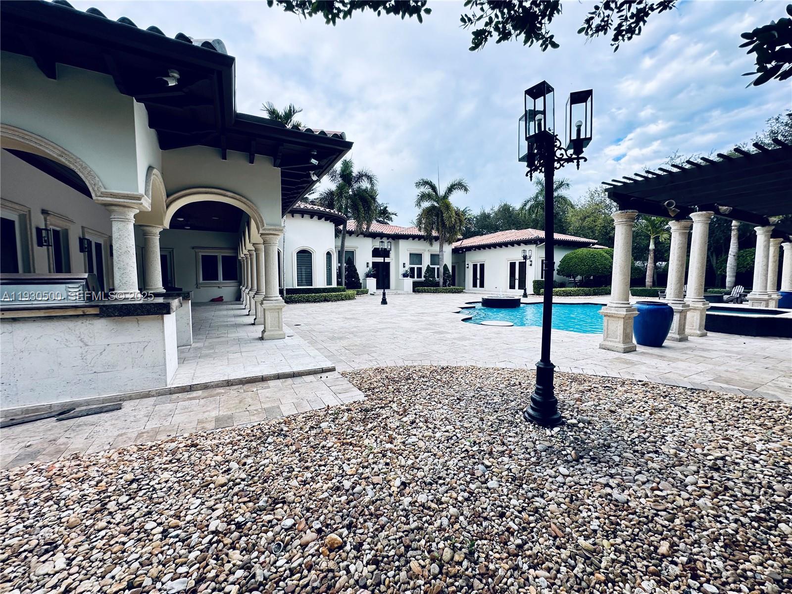 6180 Southwest 132nd Street Pinecrest, FL 33156 - Photo 59 of 75 a front view of a house with a yard