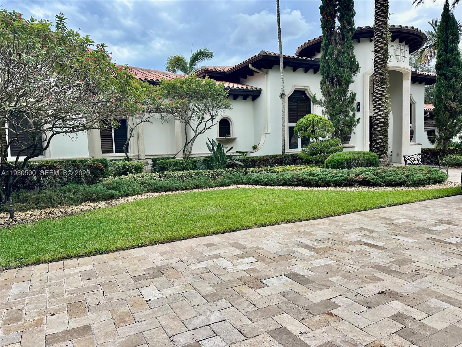 6180 Southwest 132nd Street Pinecrest, FL 33156 - Photo 67 of 75 a front view of house with yard and green space