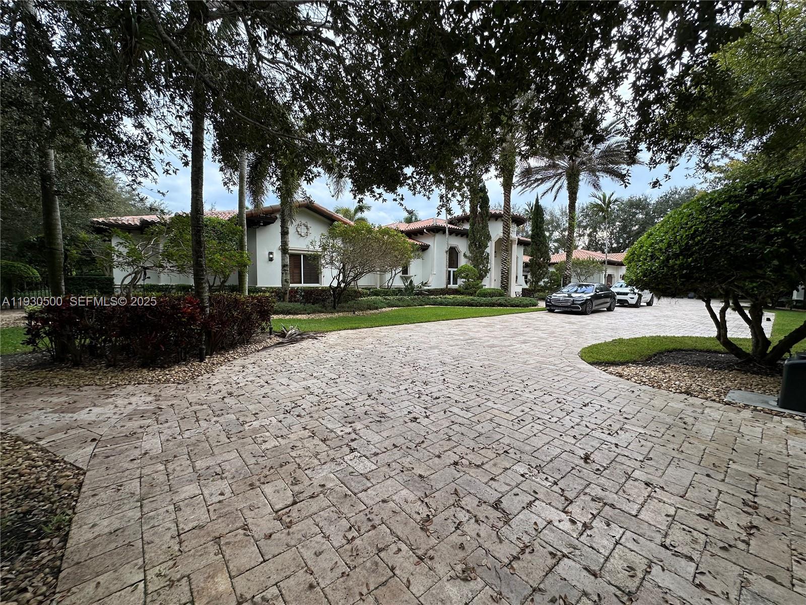 6180 Southwest 132nd Street Pinecrest, FL 33156 - Photo 70 of 75 a view of a house with a yard and pathway