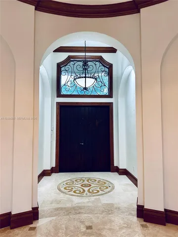 a view of a livingroom with wooden floor and stairs
