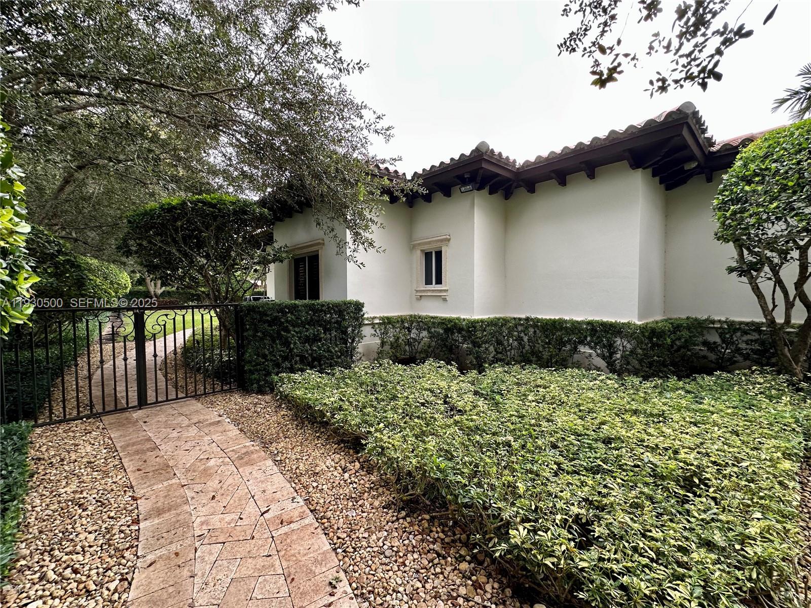 6180 Southwest 132nd Street Pinecrest, FL 33156 - Photo 73 of 75 a front view of a house with a yard
