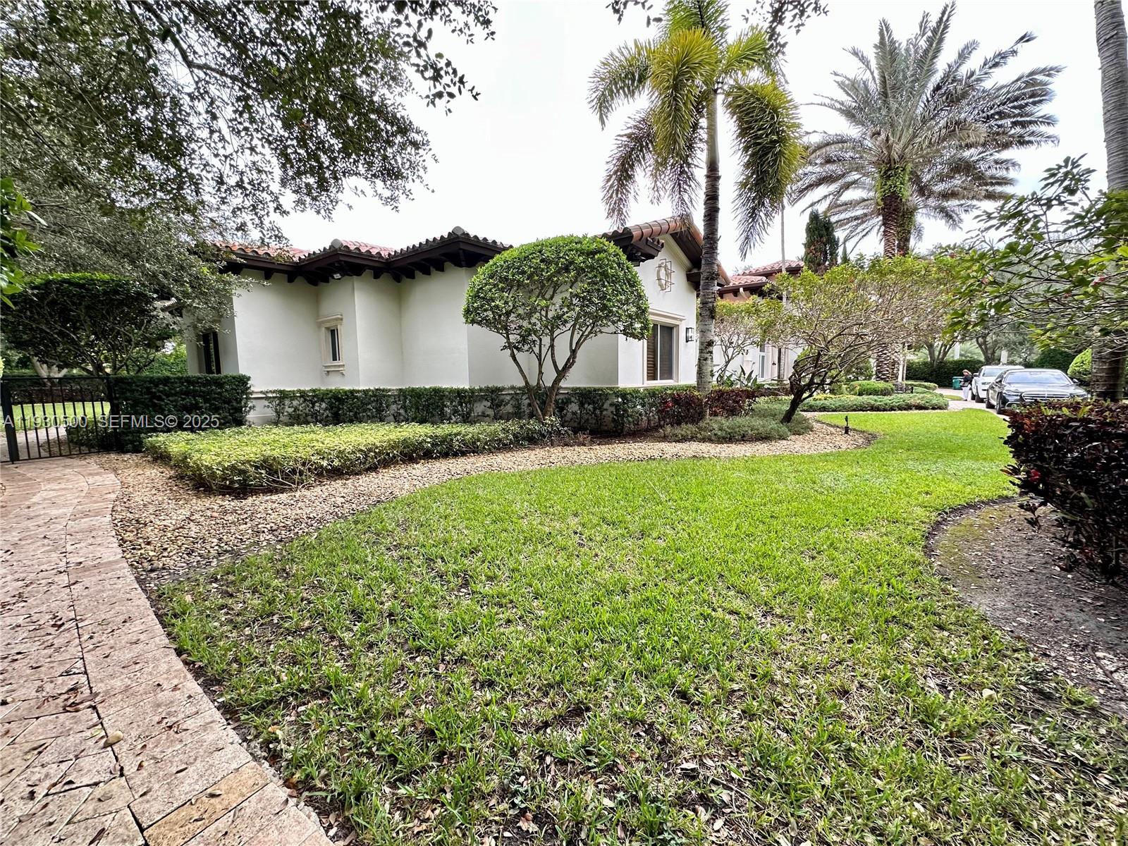 6180 Southwest 132nd Street Pinecrest, FL 33156 - Photo 74 of 75 a view of a house with a yard and potted plants