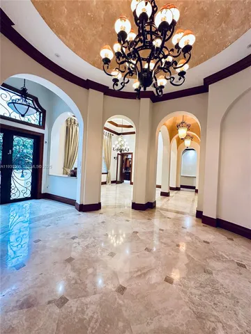 a view of a livingroom with wooden floor and stairs