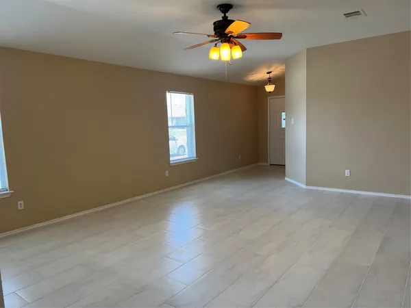 a view of an empty room with a window