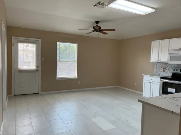 a view of an empty room with a window