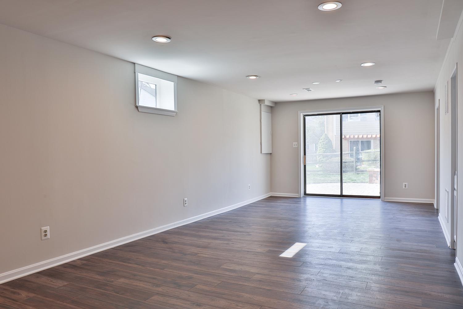 5423 Rilian Court Burke, VA 22015 - Photo 60 of 67 a view of an empty room with wooden floor and a window