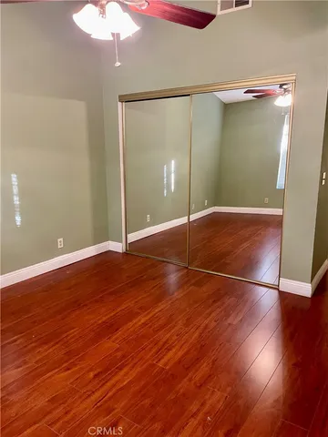 an empty room with wooden floor and door