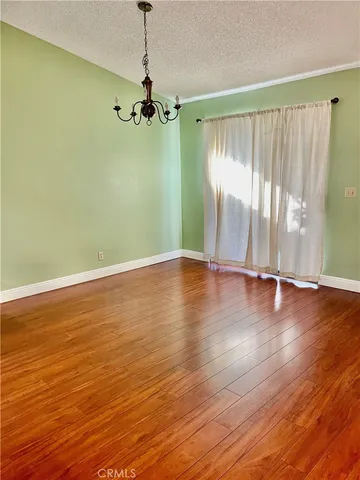 a view of room with hardwood floor and window