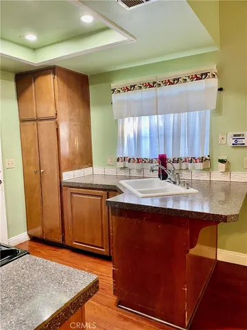 a kitchen with stainless steel appliances granite countertop a sink stove and cabinets