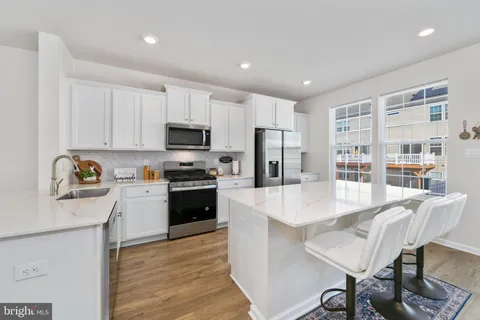 a large kitchen with kitchen island a table and chairs