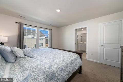 a bedroom with a large bed and a window