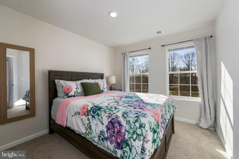 a bedroom with a bed and a window with outer view