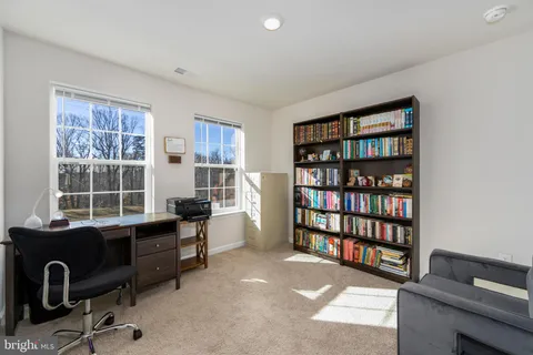 a view of a workspace with a bookshelf