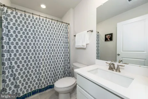 a bathroom with a sink toilet and a mirror