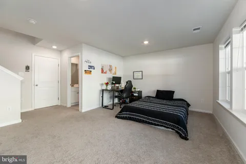 a view of room with furniture and windows