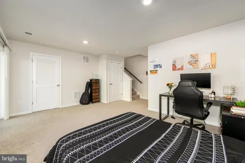 a bed room with a bed and a chair