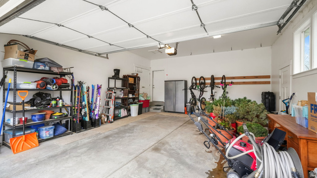 1238 Canyon View Road Midway, UT 84049 - Photo 28 of 36 Spacious two-car garage with concrete flooring, white painted walls, and overhead lighting