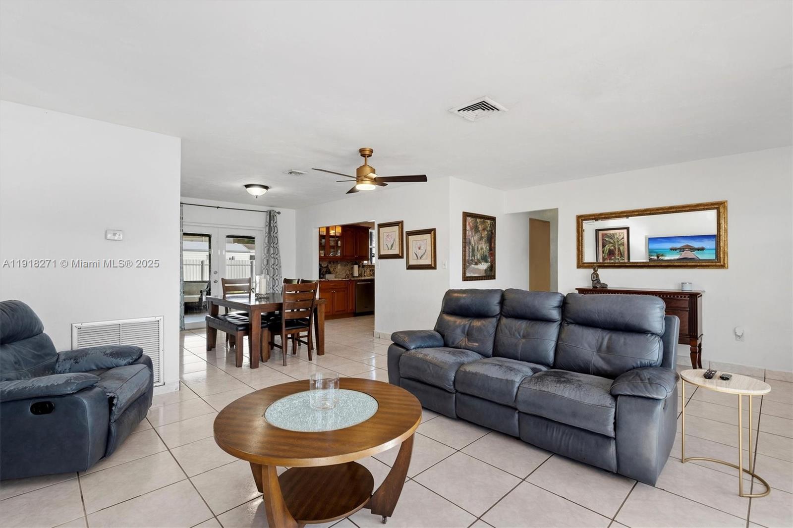9411 Southwest 30th Terrace Miami, FL 33165 - Photo 11 of 42 a living room with furniture and a dining table with wooden floor