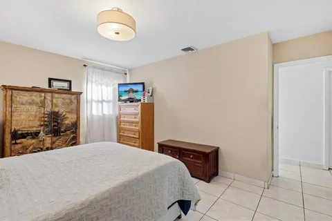 a bedroom with a bed and a large mirror