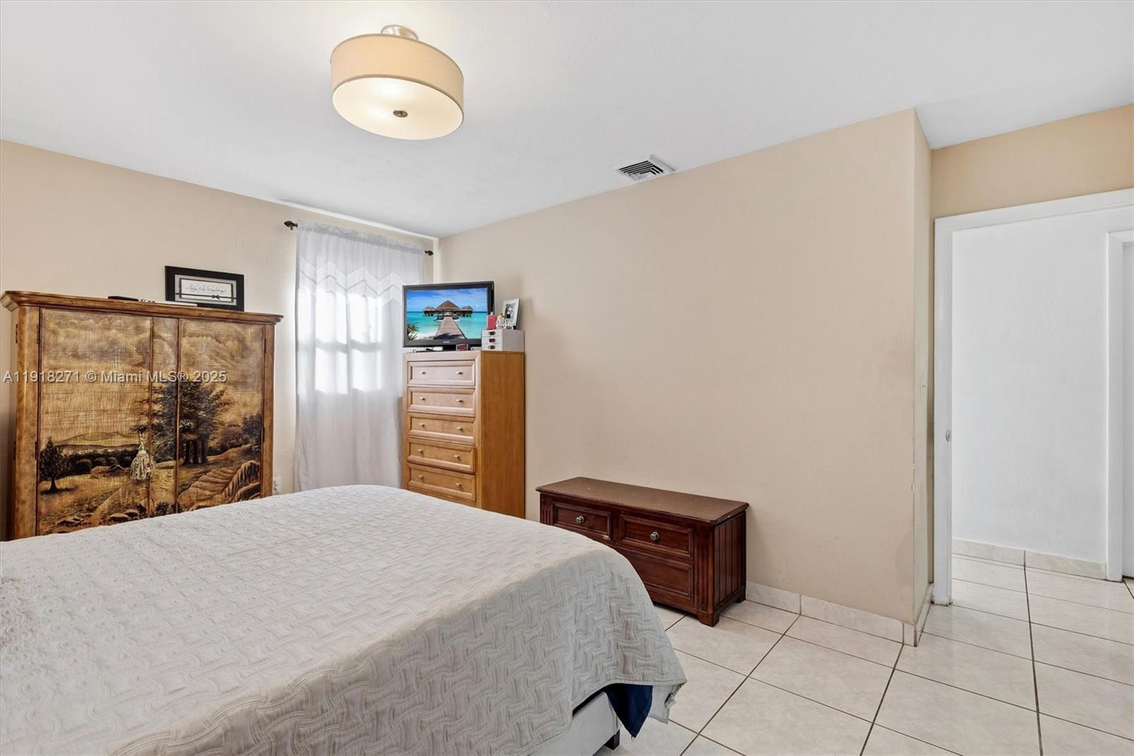 9411 Southwest 30th Terrace Miami, FL 33165 - Photo 15 of 42 a bedroom with a bed and a large mirror