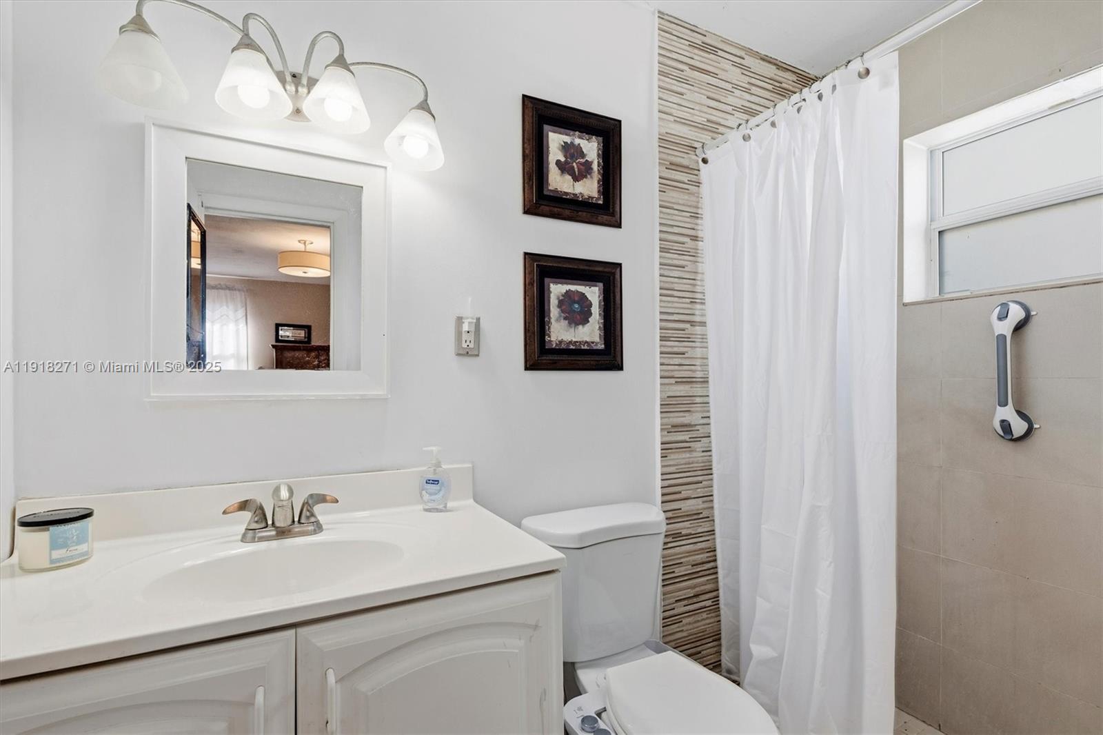 9411 Southwest 30th Terrace Miami, FL 33165 - Photo 16 of 42 a bathroom with a sink a toilet and shower