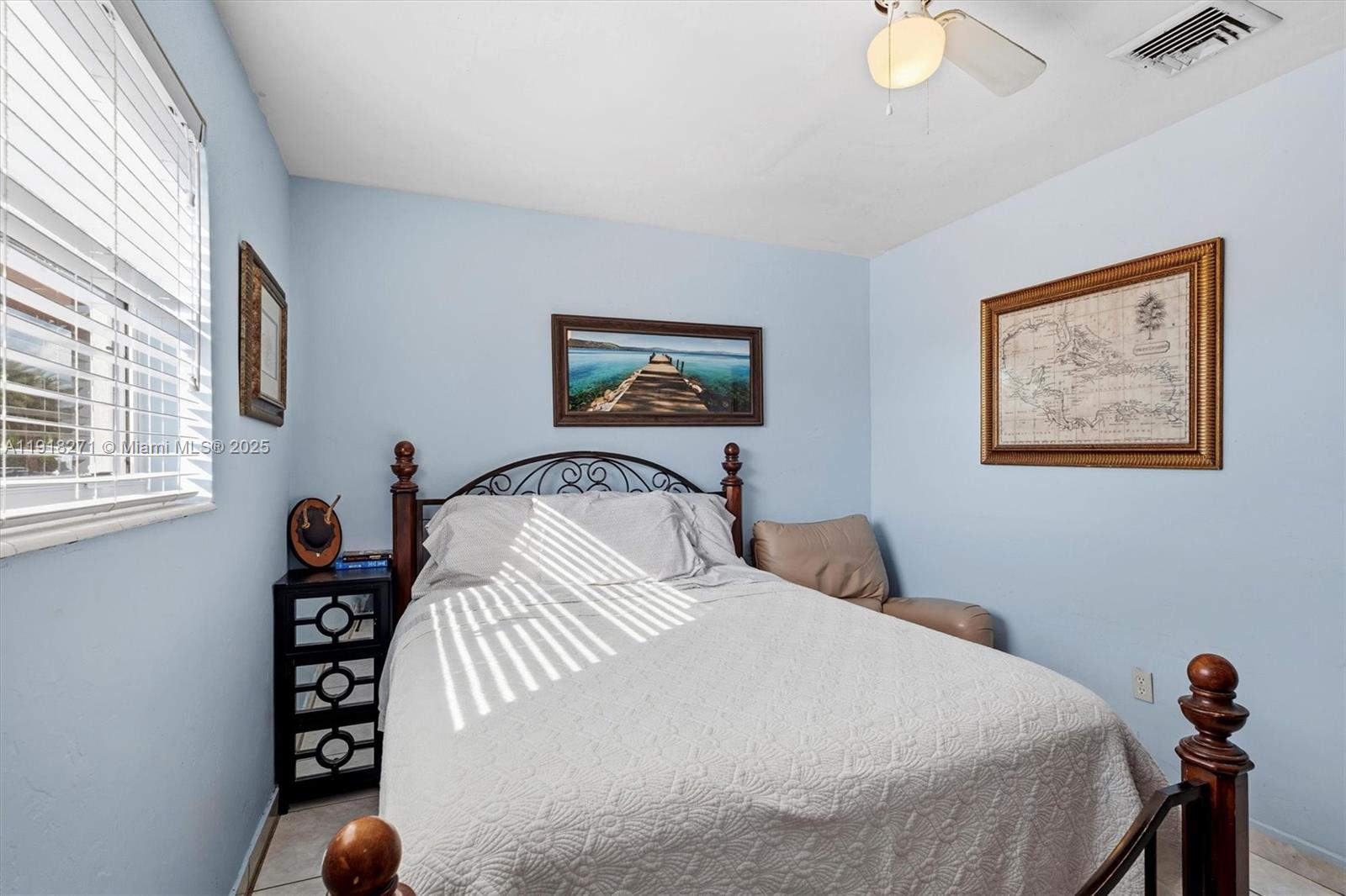 9411 Southwest 30th Terrace Miami, FL 33165 - Photo 22 of 42 a bedroom with a bed and a painting on the wall