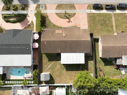 an aerial view of residential houses with outdoor space