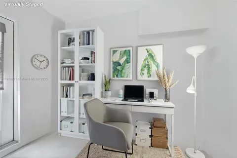 a living room with furniture a window and a clock