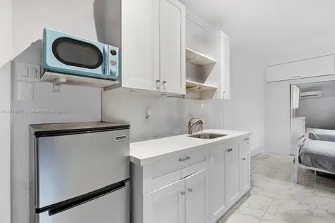 a utility room with sink dryer and washer