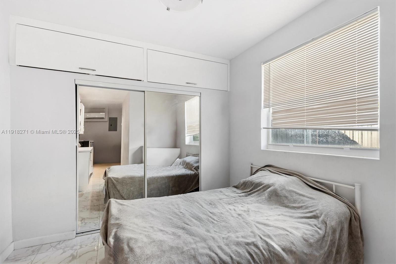 9411 Southwest 30th Terrace Miami, FL 33165 - Photo 41 of 42 a bedroom with a bed and a large mirror