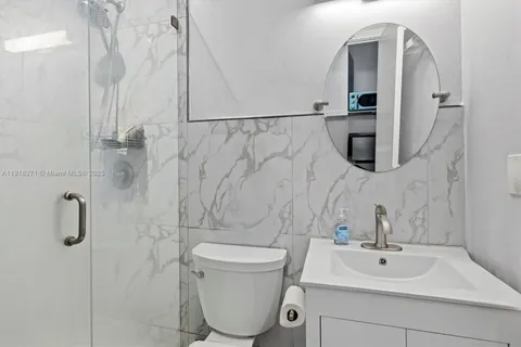 a bathroom with a toilet sink and shower