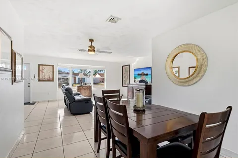 a view of a dining room with furniture and a chandelier