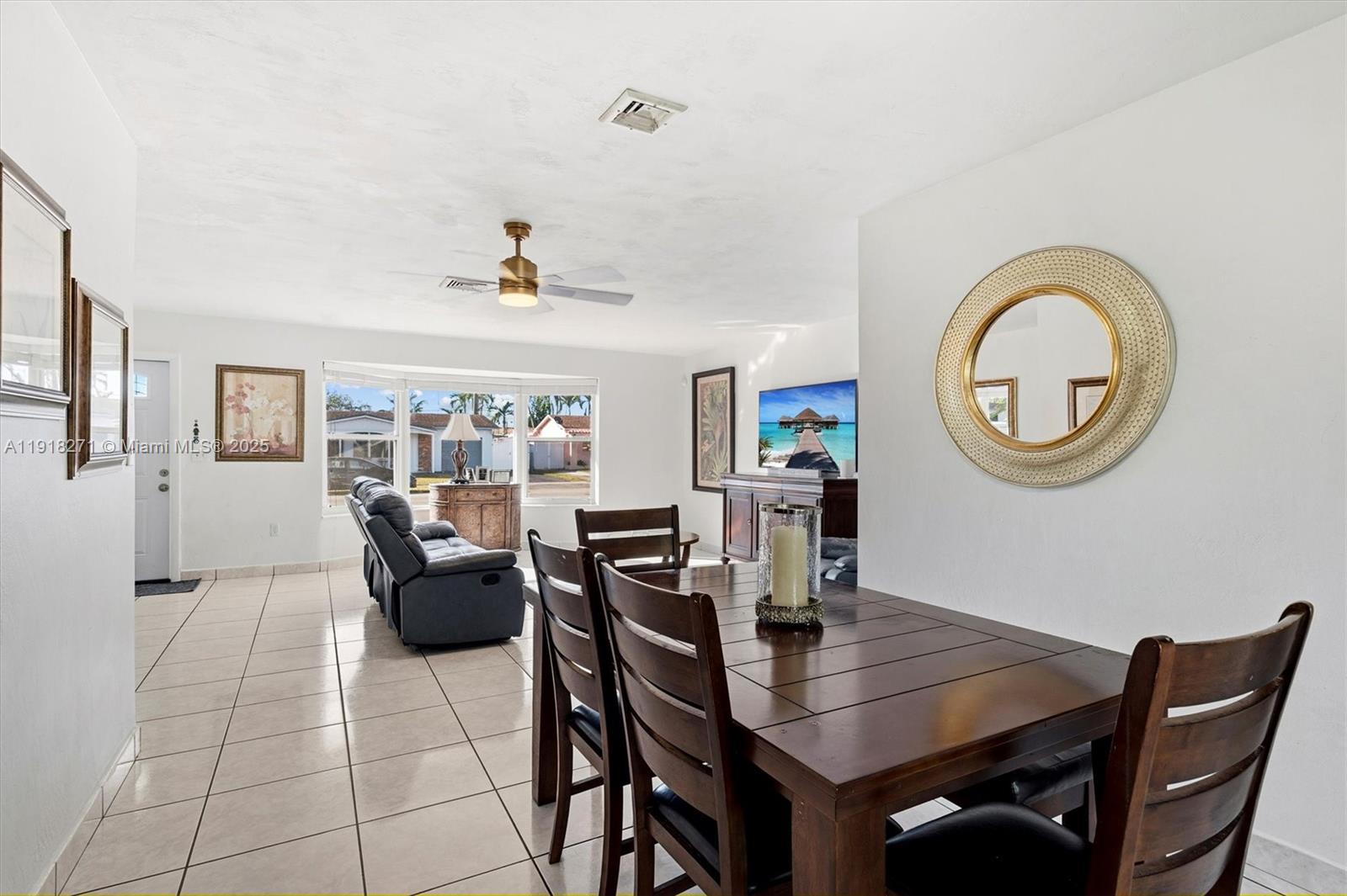 9411 Southwest 30th Terrace Miami, FL 33165 - Photo 5 of 42 a view of a dining room with furniture and a chandelier