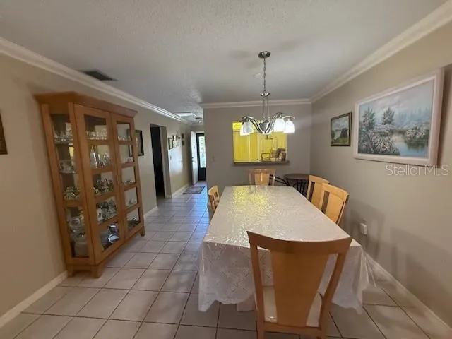 a large hall with wooden floor and chandelier