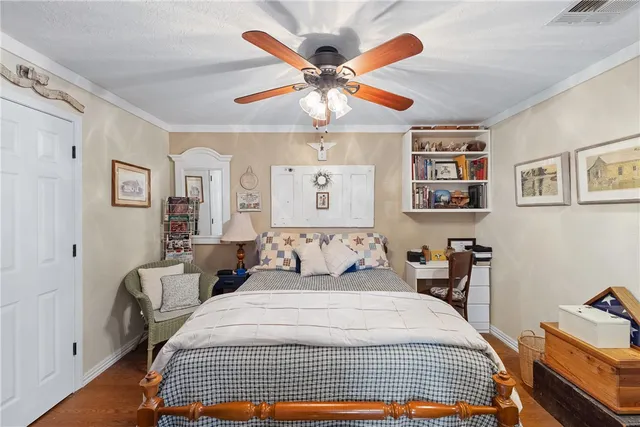 a dining room with furniture a chandelier and wooden floor