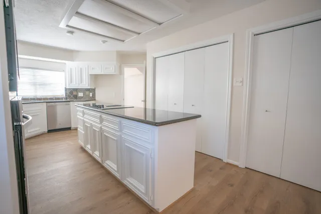 a kitchen with stainless steel appliances granite countertop a sink and a stove top oven
