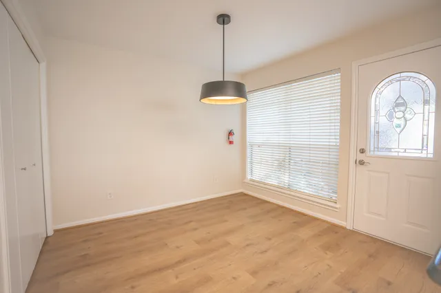 a view of a room with window wooden floor and windows