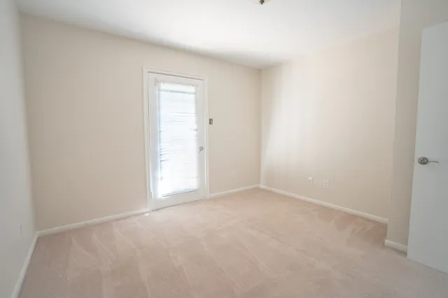 a view of an empty room and a window