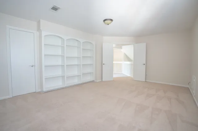 a view of an empty room with a closet