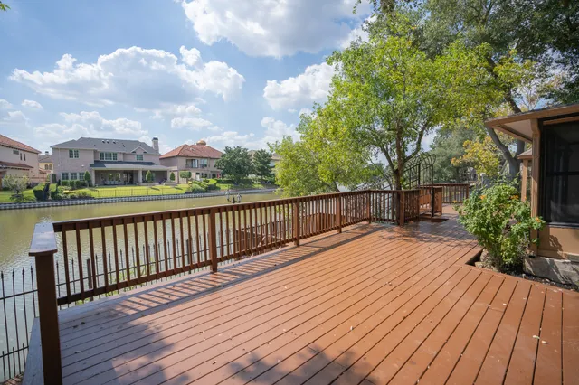 a balcony with wooden floor and city view