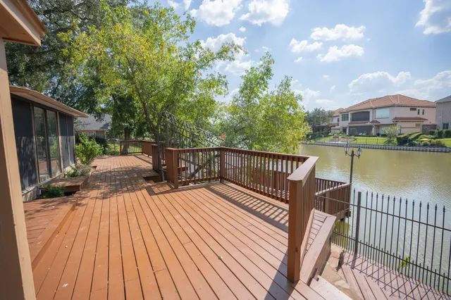 a view of a roof deck with chair and wooden floor