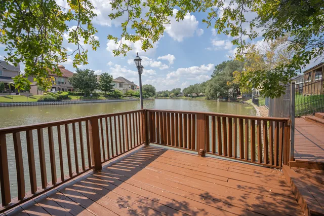 a terrace view with wooden floor and fence