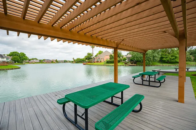 a view of swimming pool with lounge chair in front of house