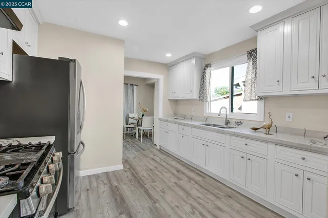 a kitchen with wooden floors and appliances